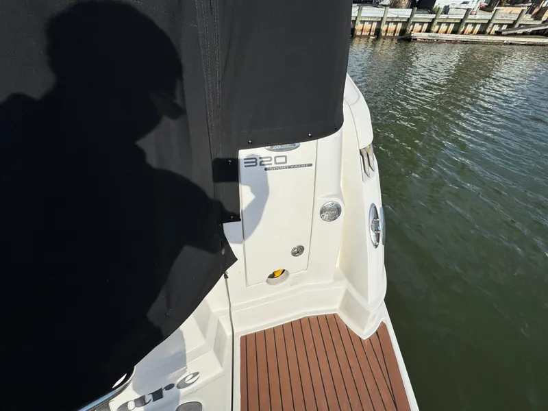 Slide: The Image of 2011 Monterey 320 Sport Yacht on water, featuring deck and branding details. - 31