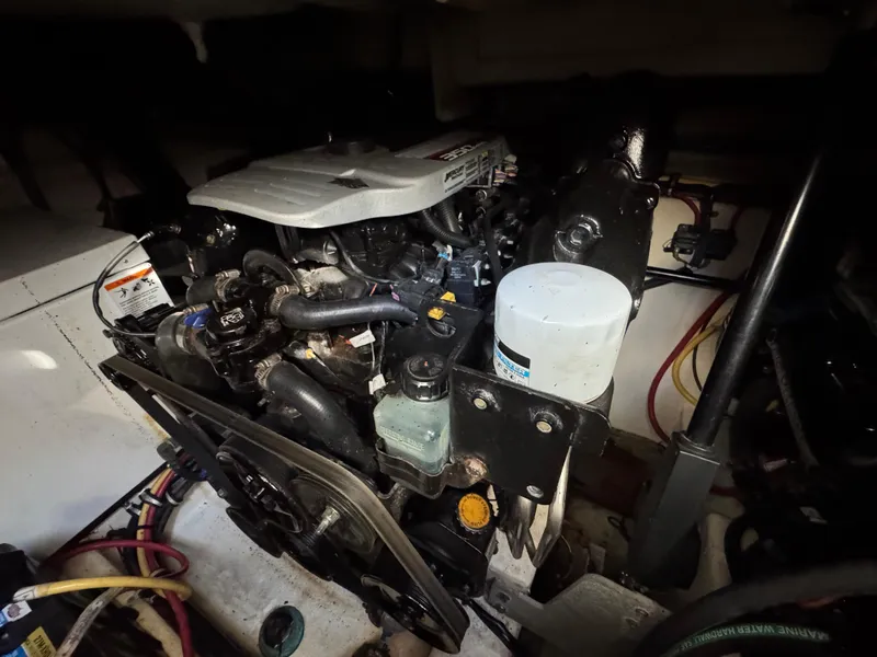 Slide: The Image of Engine compartment of a 2011 Monterey 320 Sport Yacht, showcasing mechanical components and wiring. - 4