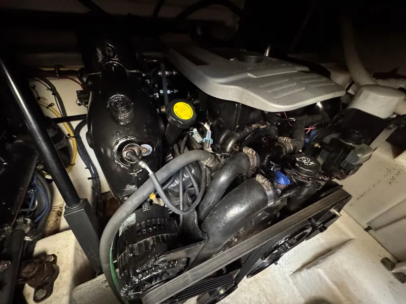 Slide: The Image of Engine compartment of a 2011 Monterey 320 Sport Yacht, showcasing mechanical components and hoses. - 5