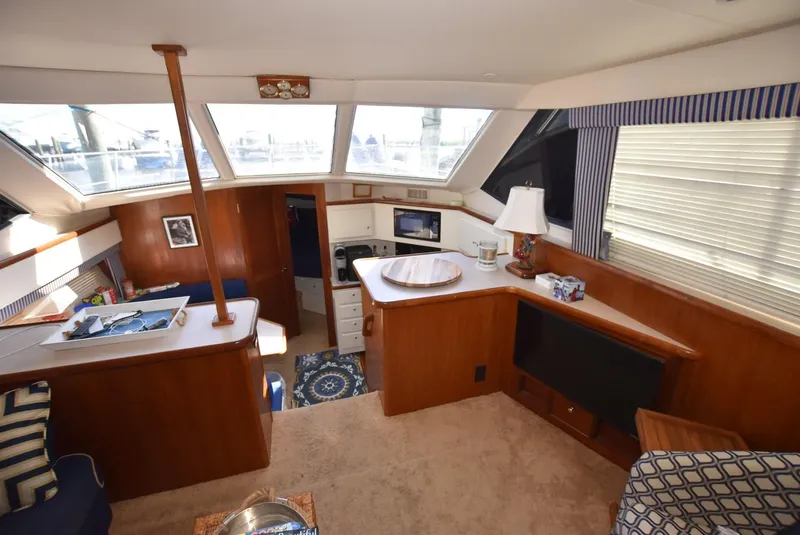 Slide: The Image of 1997 Carver 405 Aft Cabin Motoryacht interior with cozy seating, wood accents, and natural light. - 14