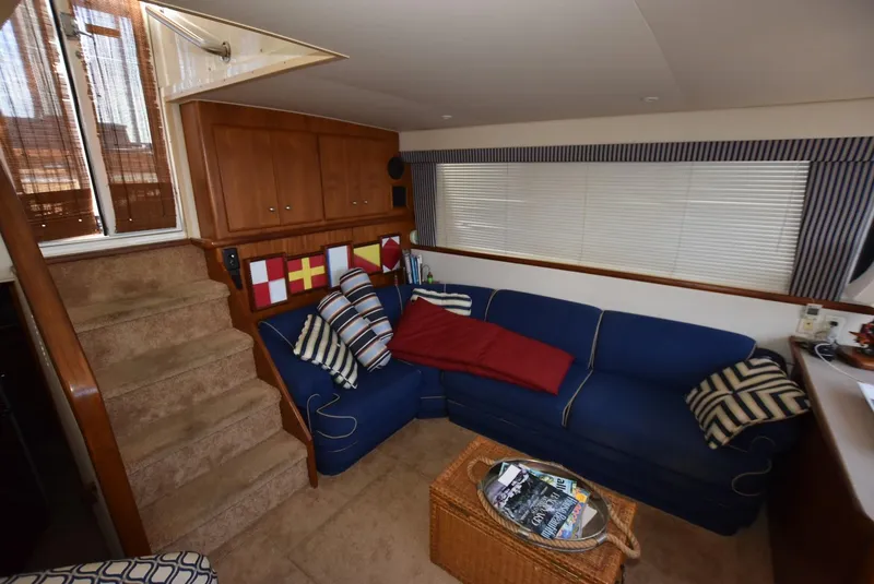 Slide: The Image of Interior of 1997 Carver 405 Aft Cabin Motoryacht with blue sofa and nautical decor. - 15