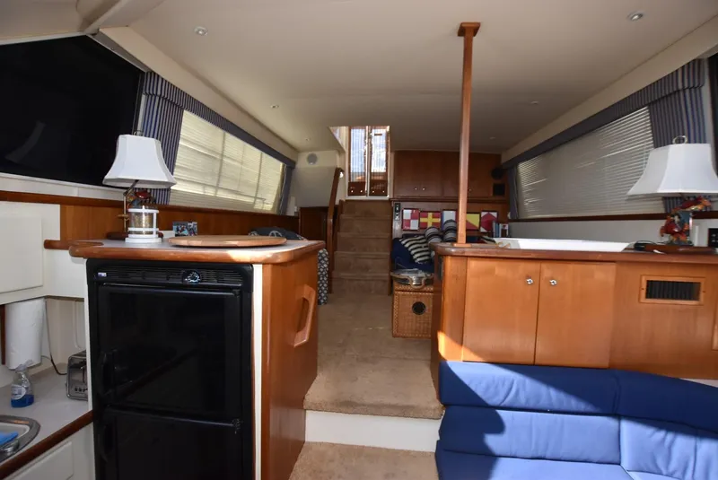 Slide: The Image of Interior of 1997 Carver 405 Aft Cabin Motoryacht with cozy seating and wooden cabinetry. - 23