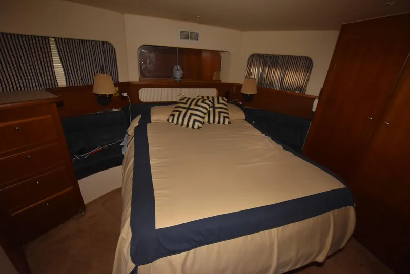 Slide: The Image of 1997 Carver 405 Aft Cabin Motoryacht bedroom with cozy bed and nautical decor. - 28