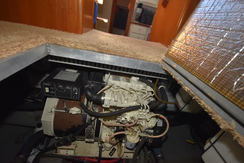 Slide: The Image of 1997 Carver 405 Aft Cabin Motoryacht engine room with visible generator and wiring. - 36