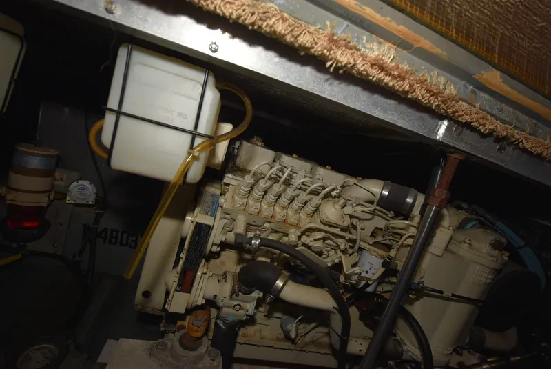 Slide: The Image of Engine compartment of a 1997 Carver 405 Aft Cabin Motoryacht, showcasing mechanical components. - 37