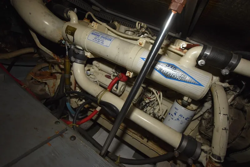 Slide: The Image of Engine compartment of 1997 Carver 405 Aft Cabin Motoryacht, showcasing mechanical components. - 39