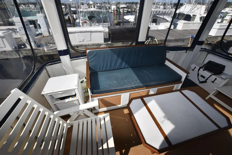 Slide: The Image of 1997 Carver 405 Aft Cabin Motoryacht interior with seating and table, docked at marina. - 6