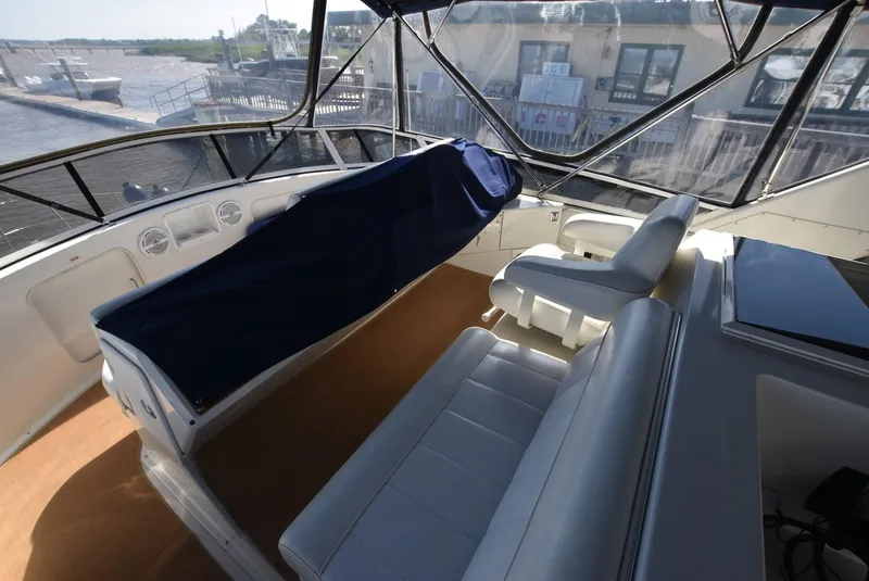 Slide: The Image of 1997 Carver 405 Aft Cabin Motoryacht interior with seating and covered dashboard. - 8
