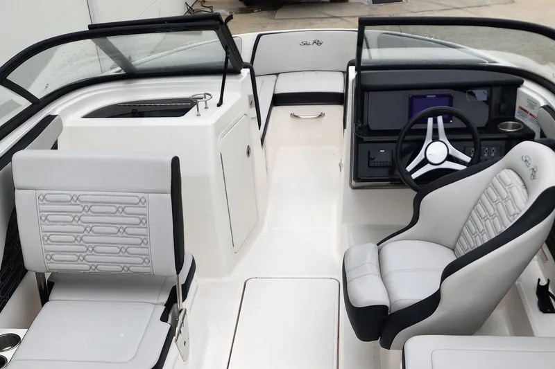 Slide: The Image of 2024 Sea Ray SPX 210 OB boat interior with modern seating and steering console. - 10