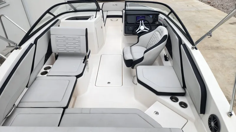 Slide: The Image of 2024 Sea Ray SPX 210 OB boat interior with modern seating and steering console. - 11