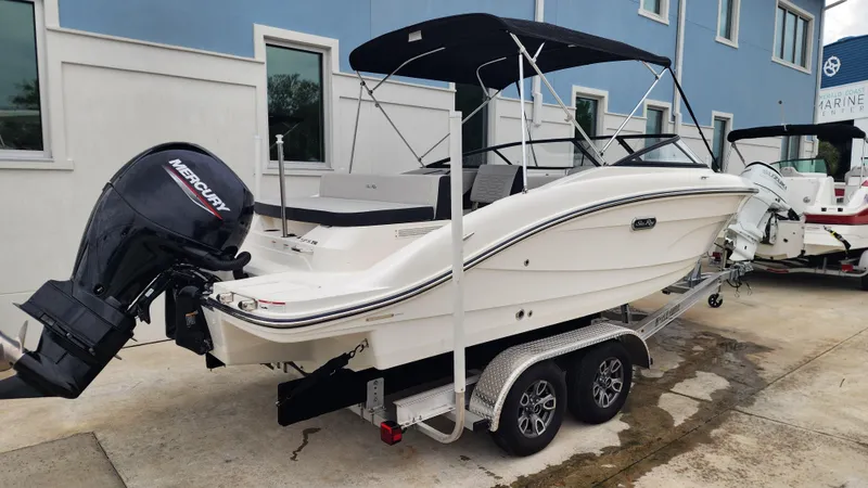 Slide: The Image of 2024 Sea Ray SPX 210 OB boat on trailer, featuring a sleek design and outboard motor. - 5