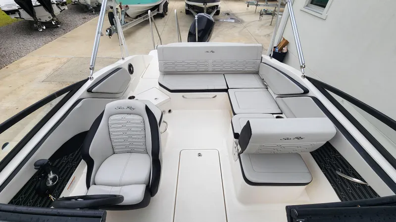 Slide: The Image of 2024 Sea Ray SPX 210 OB boat interior with plush seating and modern design. - 8