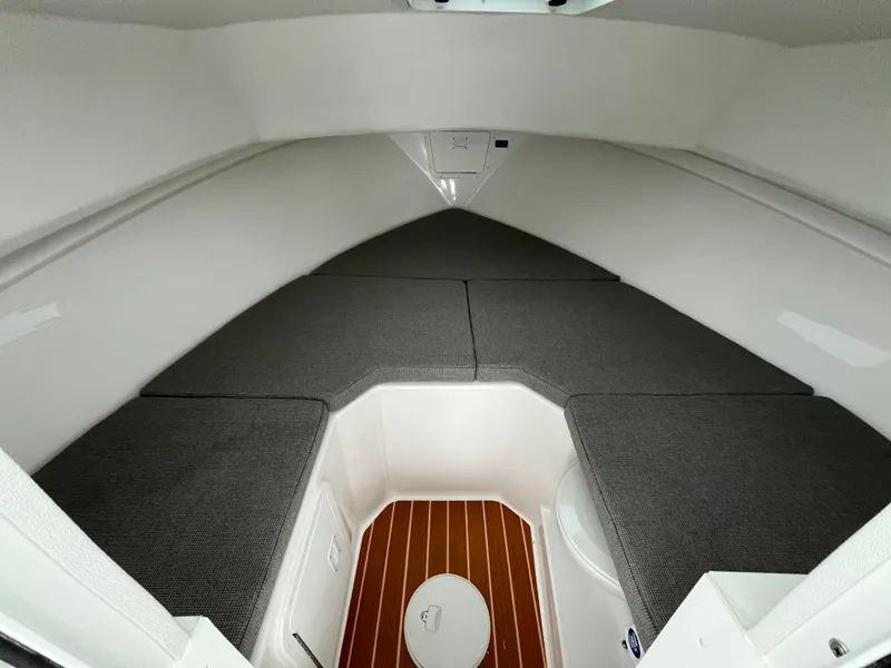 Slide: The Image of 2025 Steiger Craft 255 Miami cabin interior with cushioned seating and wooden flooring. - 10