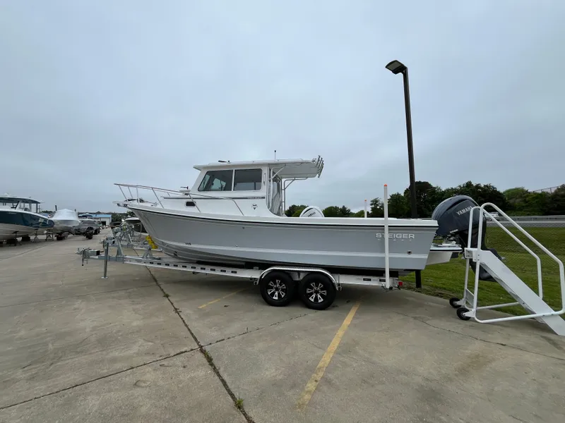 Slide: The Image of 2025 Steiger Craft 255 Miami boat on trailer in parking lot. - 12