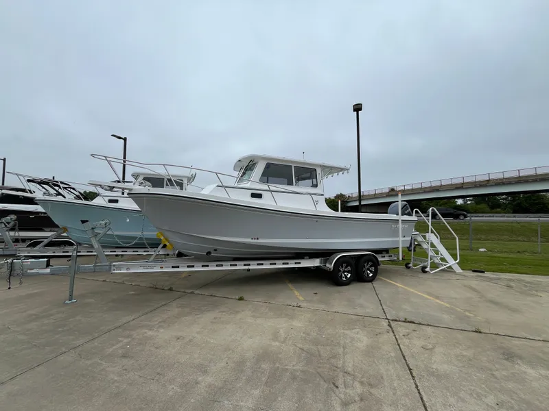 Slide: The Image of 2025 Steiger Craft 255 Miami boat on trailer, parked outdoors. - 13