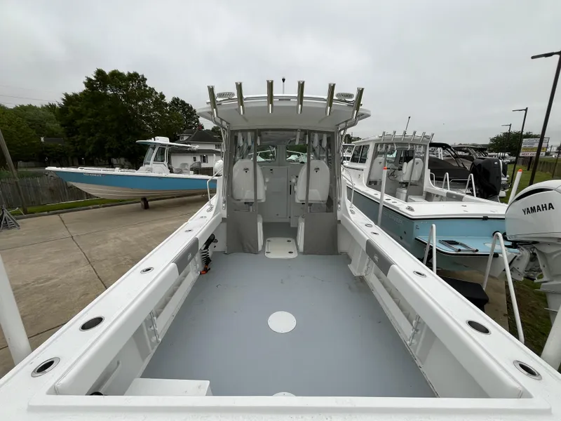 Slide: The Image of 2025 Steiger Craft 255 Miami boat, spacious deck, docked with other boats. - 3