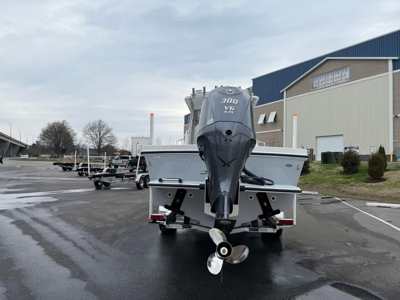 Slide: The Image of 2025 Steiger Craft 255 Miami boat with powerful outboard motor in a marina setting. - 4