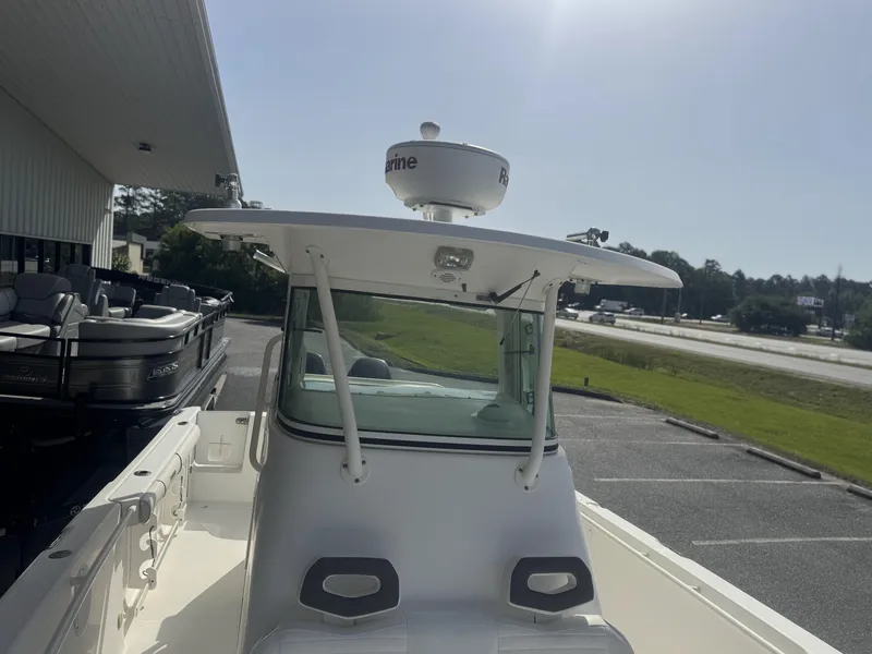Slide: The Image of 2007 Everglades 260CC boat with radar, parked near a building. - 10