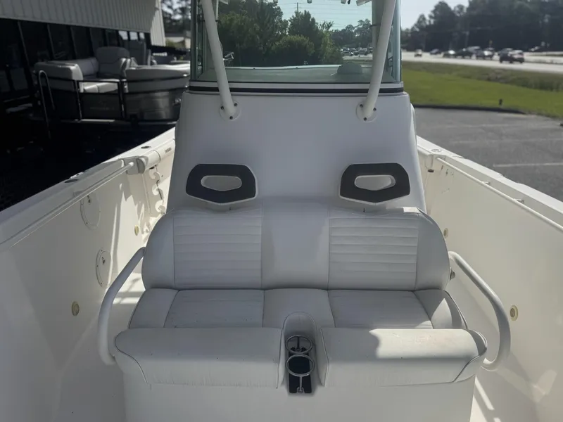 Slide: The Image of 2007 Everglades 260CC boat interior with white seating and console. - 12