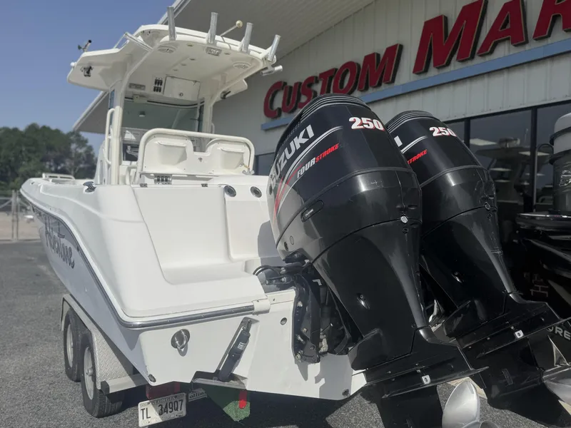 Slide: The Image of 2007 Everglades 260CC boat with dual Suzuki 250 engines at Custom Marine dealership. - 4