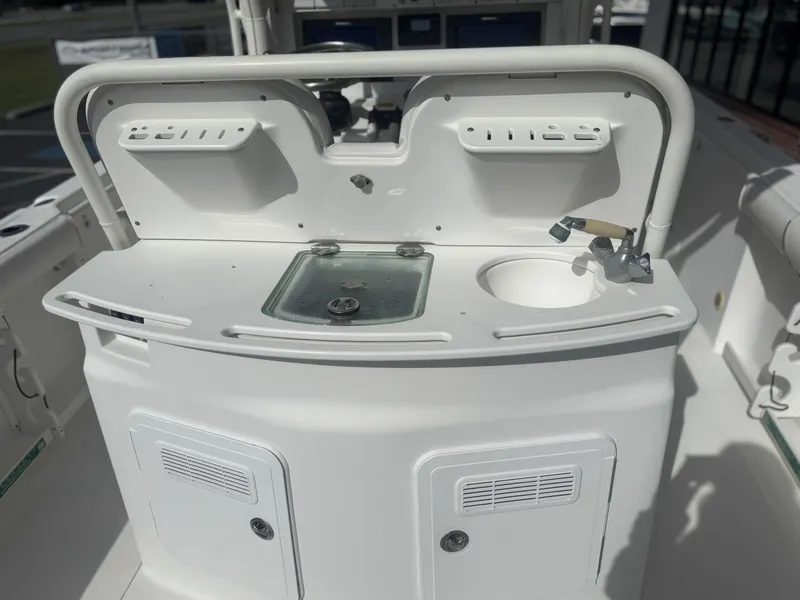 Slide: The Image of 2007 Everglades 260CC boat console with sink and storage compartments. - 9
