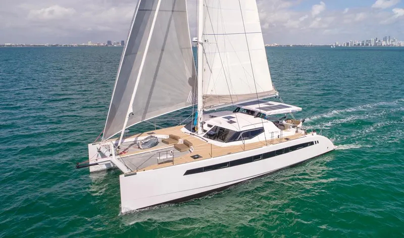 Slide: The Image of 2025 Seawind 1600 Passagemaker sailing on open sea under clear skies. - 13