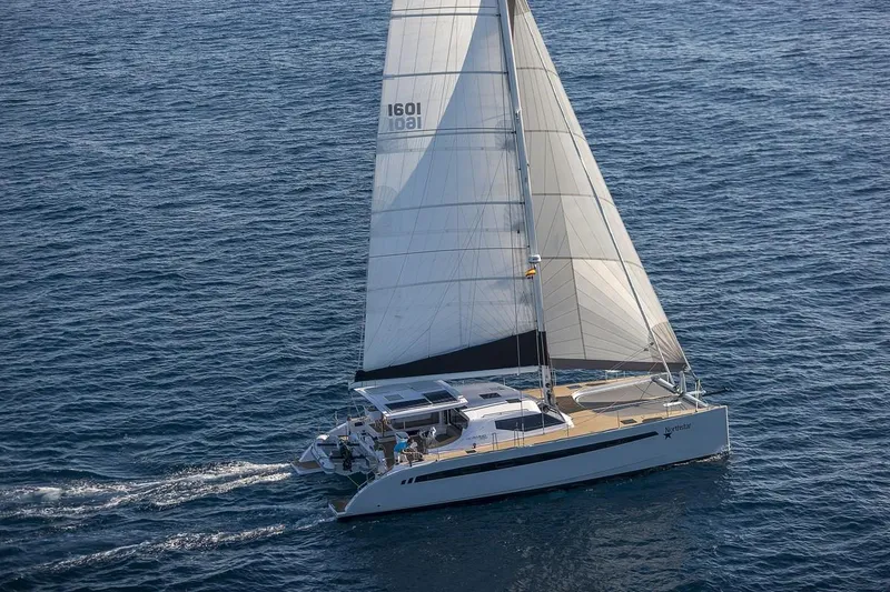 Slide: The Image of 2025 Seawind 1600 Passagemaker sailing on open ocean waters. - 14