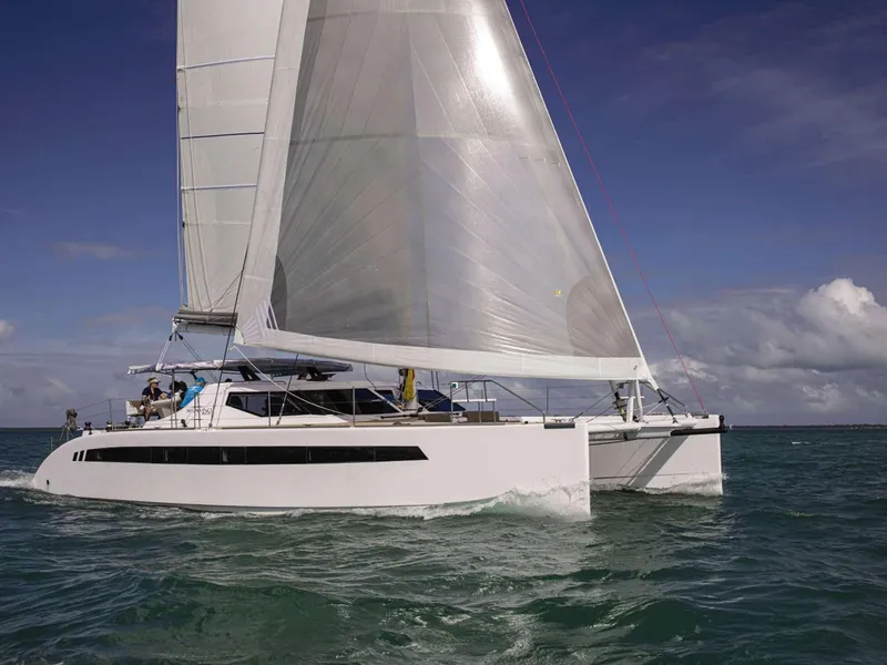 Slide: The Image of 2025 Seawind 1600 Passagemaker catamaran sailing on open water under clear skies. - 15