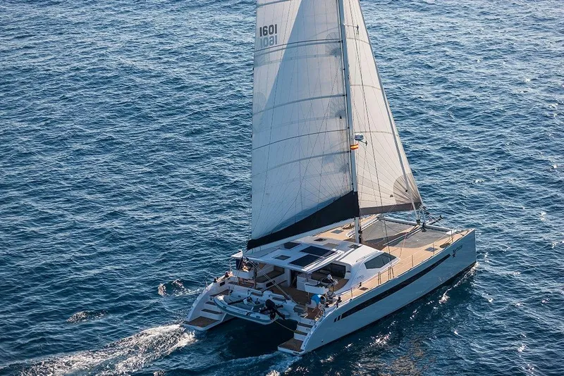 Slide: The Image of 2025 Seawind 1600 Passagemaker catamaran sailing on open ocean waters. - 17