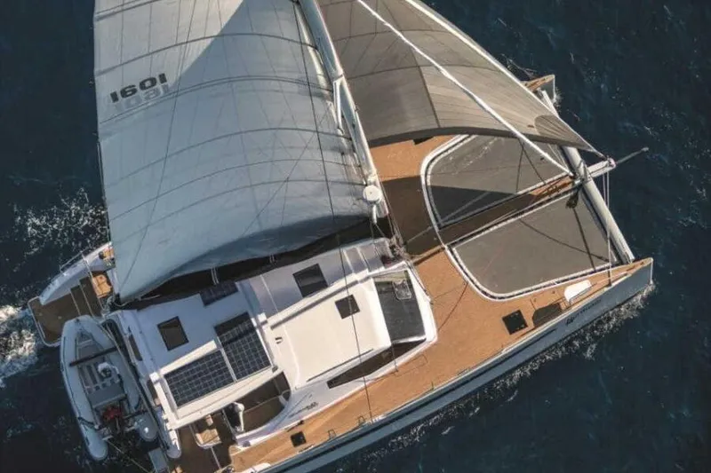 Slide: The Image of 2025 Seawind 1600 Passagemaker sailing catamaran on open water, aerial view. - 20