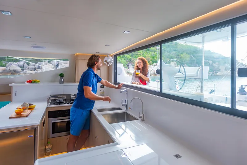 Slide: The Image of Interior of 2025 Seawind 1600 Passagemaker yacht with modern kitchen and scenic view. - 29