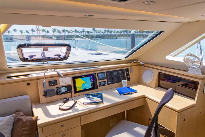 Slide: The Image of Interior of 2025 Seawind 1600 Passagemaker yacht with navigation equipment and scenic window view. - 37