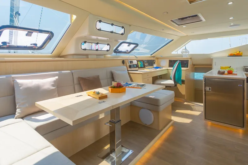 Slide: The Image of Luxurious interior of 2025 Seawind 1600 Passagemaker yacht with modern seating and navigation area. - 39