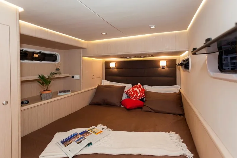Slide: The Image of Luxurious cabin interior of 2025 Seawind 1600 Passagemaker with cozy bedding and ambient lighting. - 42