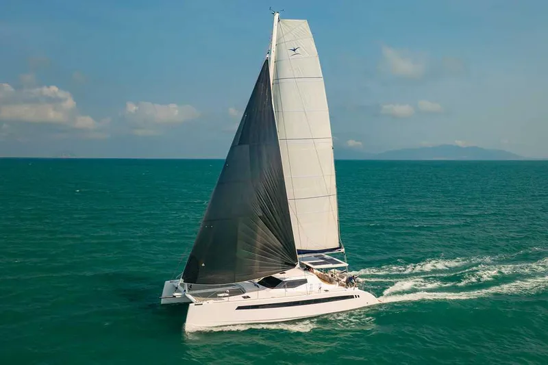 Slide: The Image of 2025 Seawind 1600 Passagemaker sailing on open sea under clear skies. - 6