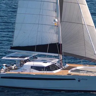 Slide: The Image of 2025 Seawind 1600 Passagemaker sailing on open water, showcasing sleek design and spacious deck. - 8