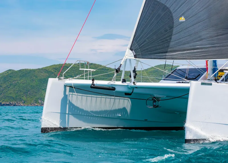 Slide: The Image of 2025 Seawind 1600 Passagemaker catamaran sailing in clear blue waters. - 9