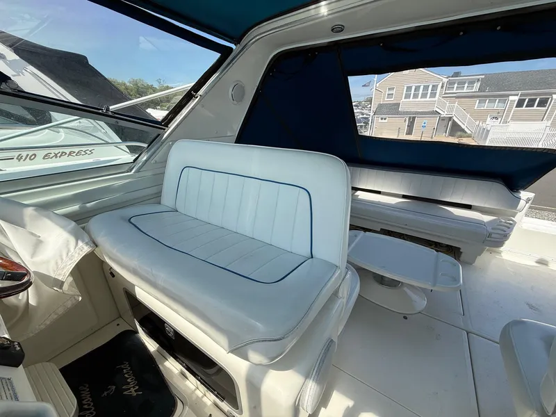 Slide: The Image of Interior of a 1995 Sea Ray 400 Express Cruiser with white seating and blue accents. - 17