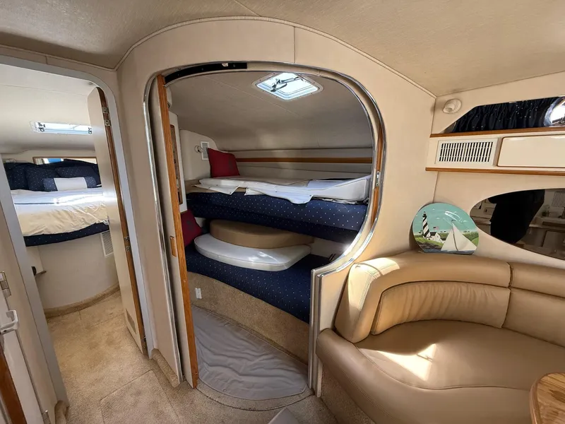 Slide: The Image of Interior of 1995 Sea Ray 400 Express Cruiser with cozy bunks and seating area. - 25