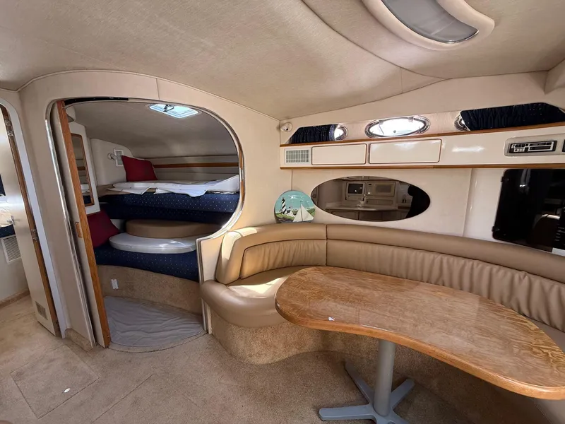 Slide: The Image of Interior of 1995 Sea Ray 400 Express Cruiser with cozy seating and sleeping area. - 26