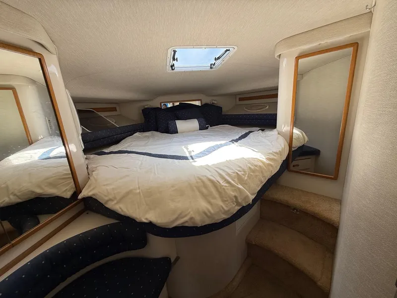 Slide: The Image of 1995 Sea Ray 400 Express Cruiser cabin with bed, mirrors, and skylight. - 28
