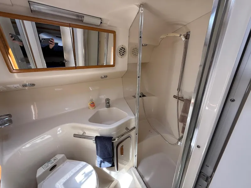 Slide: The Image of Bathroom interior of 1995 Sea Ray 400 Express Cruiser with shower and sink. - 30