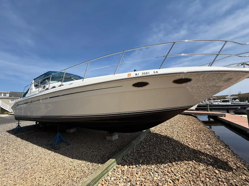 Slide: The Image of 1995 Sea Ray 400 Express Cruiser on dry dock, clear sky background. - 8