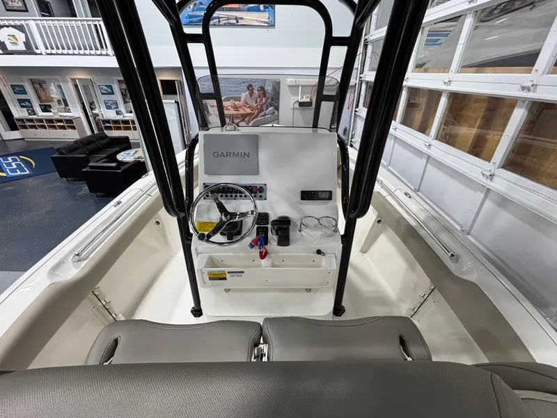 Slide: The Image of 2023 Key West 219 FS boat interior with Garmin navigation system and seating. - 13