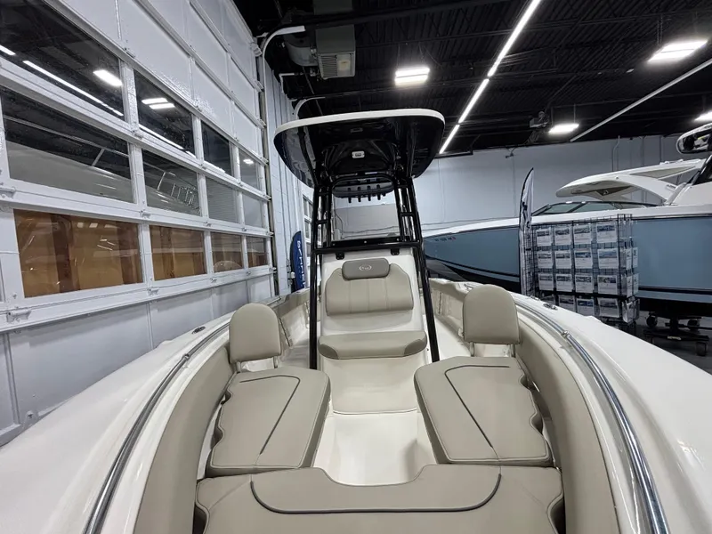 Slide: The Image of 2023 Key West 219 FS boat interior with beige seating in a showroom. - 15