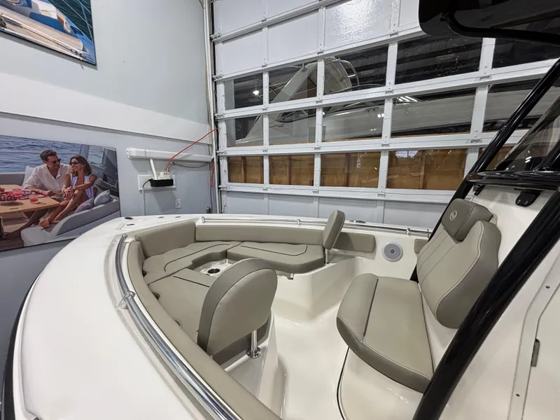 Slide: The Image of 2023 Key West 219 FS boat interior with beige seating in a showroom. - 16