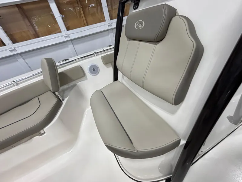 Slide: The Image of 2023 Key West 219 FS boat interior seating with beige cushions. - 18