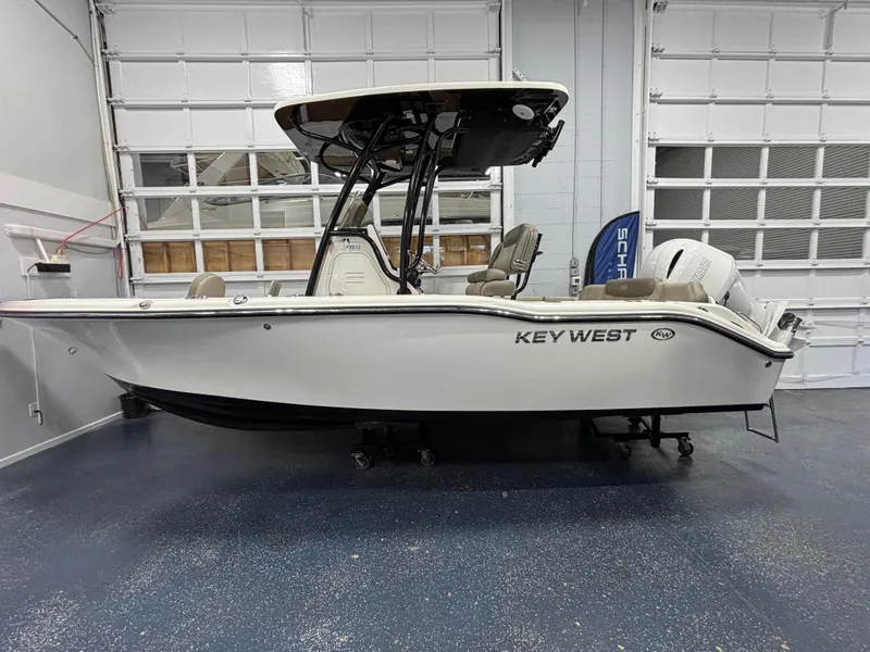 Slide: The Image of 2023 Key West 219 FS boat in showroom, side view, white exterior. - 7