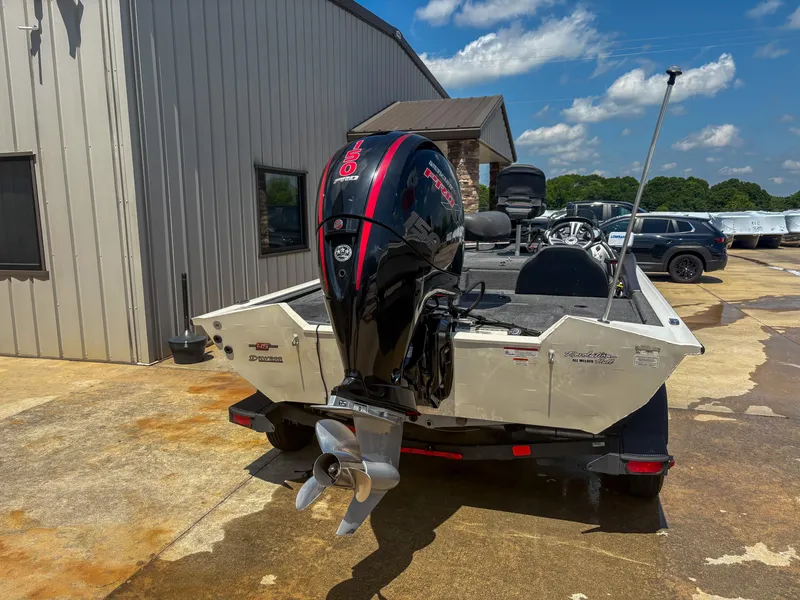 Slide: The Image of 2023 Tracker Pro Team 195 TXW Tournament Edition boat with outboard motor, parked outdoors. - 2