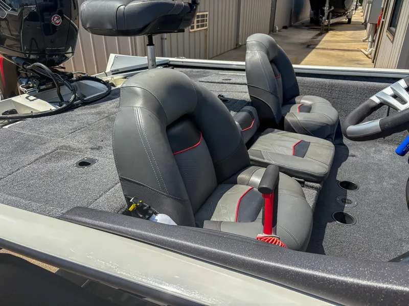 Slide: The Image of 2023 Tracker Pro Team 195 TXW Tournament Edition boat interior with gray and red seating. - 7